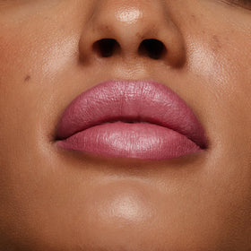 stila on model in evening setting showcasing long-wear shimmer for event-ready lips