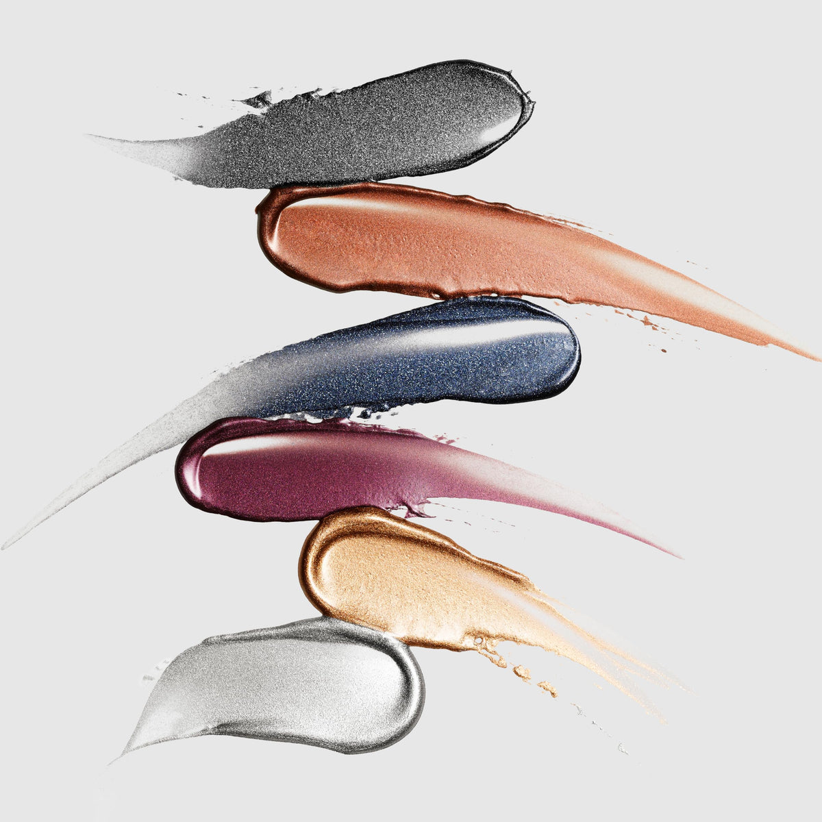 stila liner beside coin to show compact size and portability