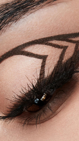 stila swatch on skin scale showing rich dark brown pigment and buildable coverage