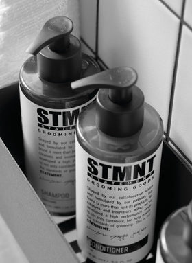 STMNT 10.1 oz bottle next to ruler to show true size and travel-friendly portability