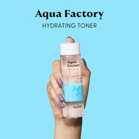 Stratia Aqua Factory on bathroom shelf with towel, suggesting daily nourishing use