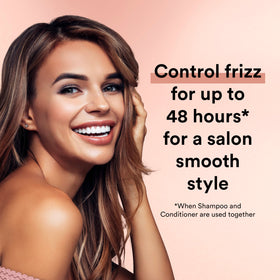 Suave bottle next to hand for scale illustrating large 28 oz size and long-lasting use