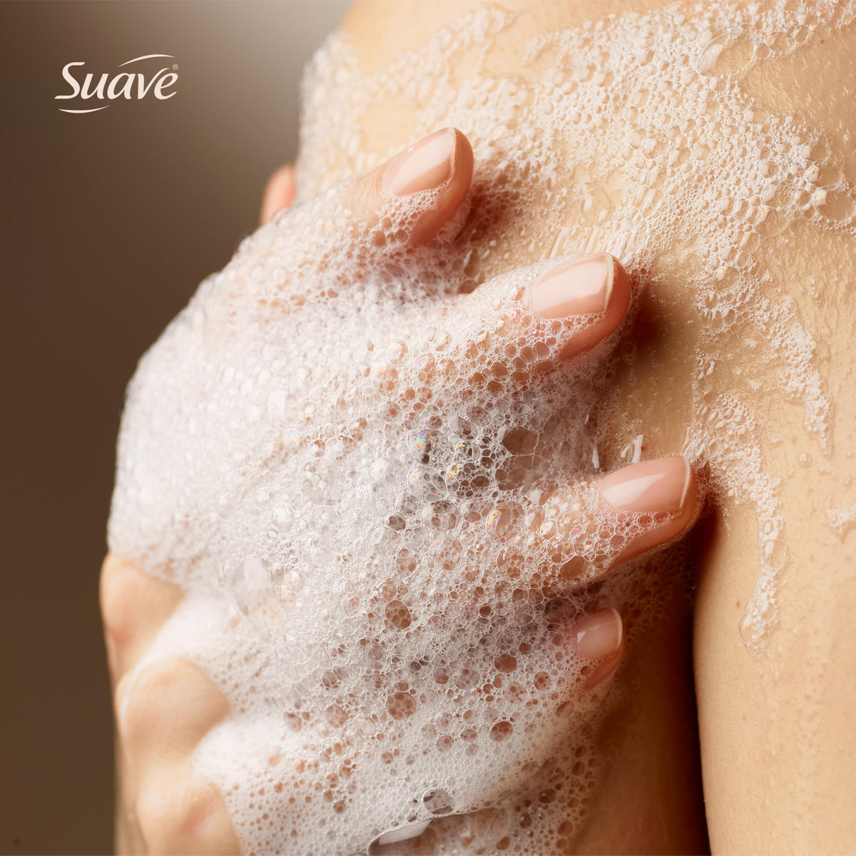Suave 18 oz bottle next to a hand to show scale and long-lasting value