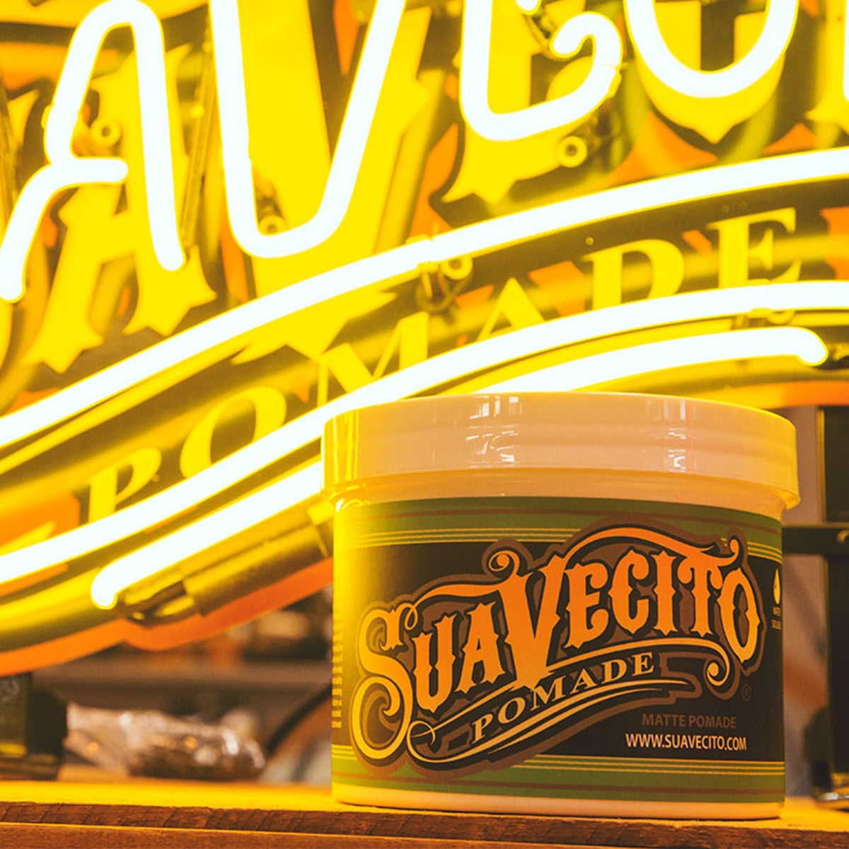 suavecito tub next to hand for scale highlighting large 32 oz size benefit