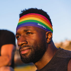 Suddora headband worn under bicycle helmet demonstrating low-profile fit benefit