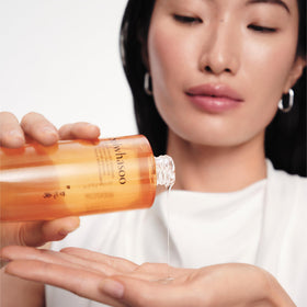 Sulwhasoo bottle held in hand to show actual size and travel-friendly scale