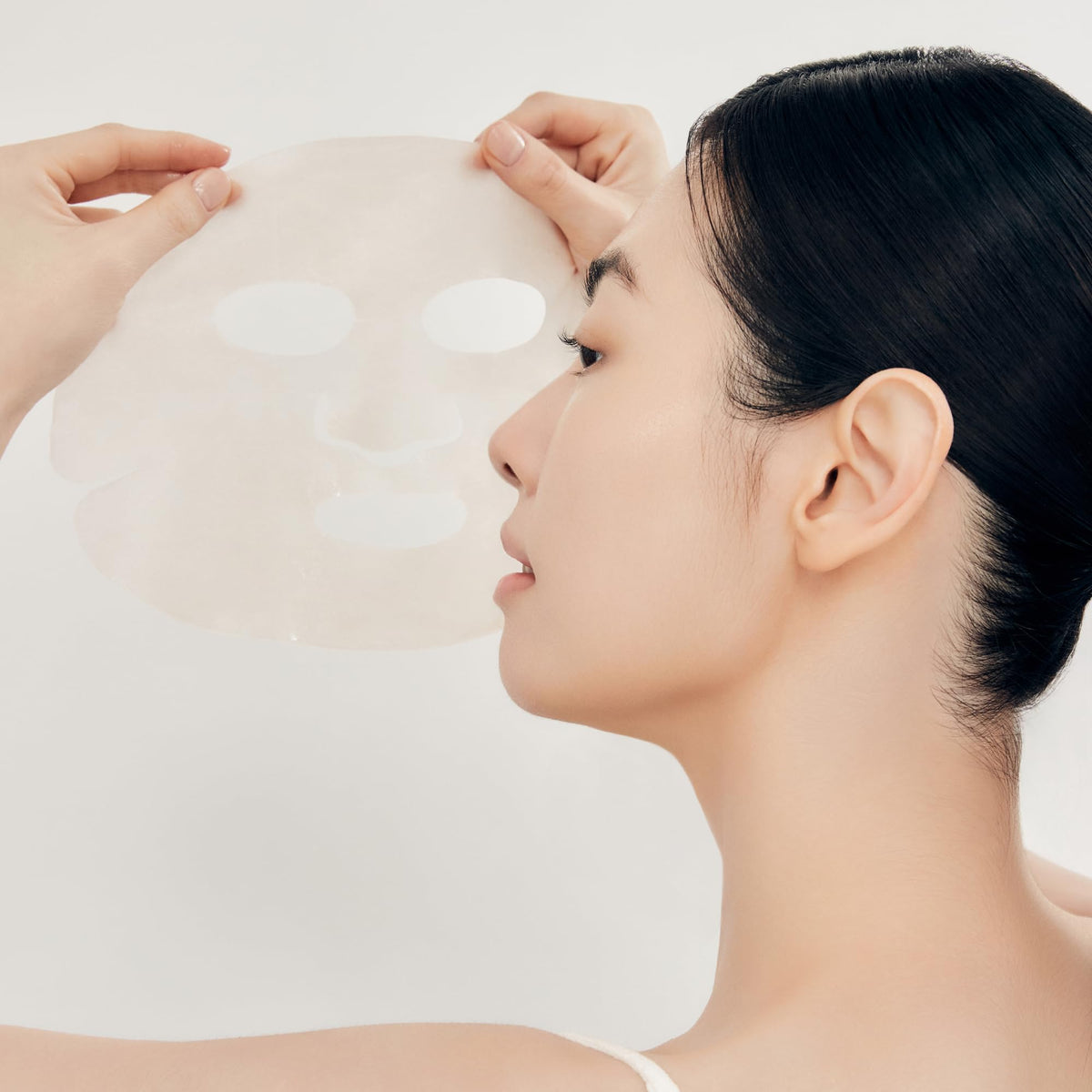 Sulwhasoo serum drops beside ginseng root illustrating potent ingredients and concentrated hydration