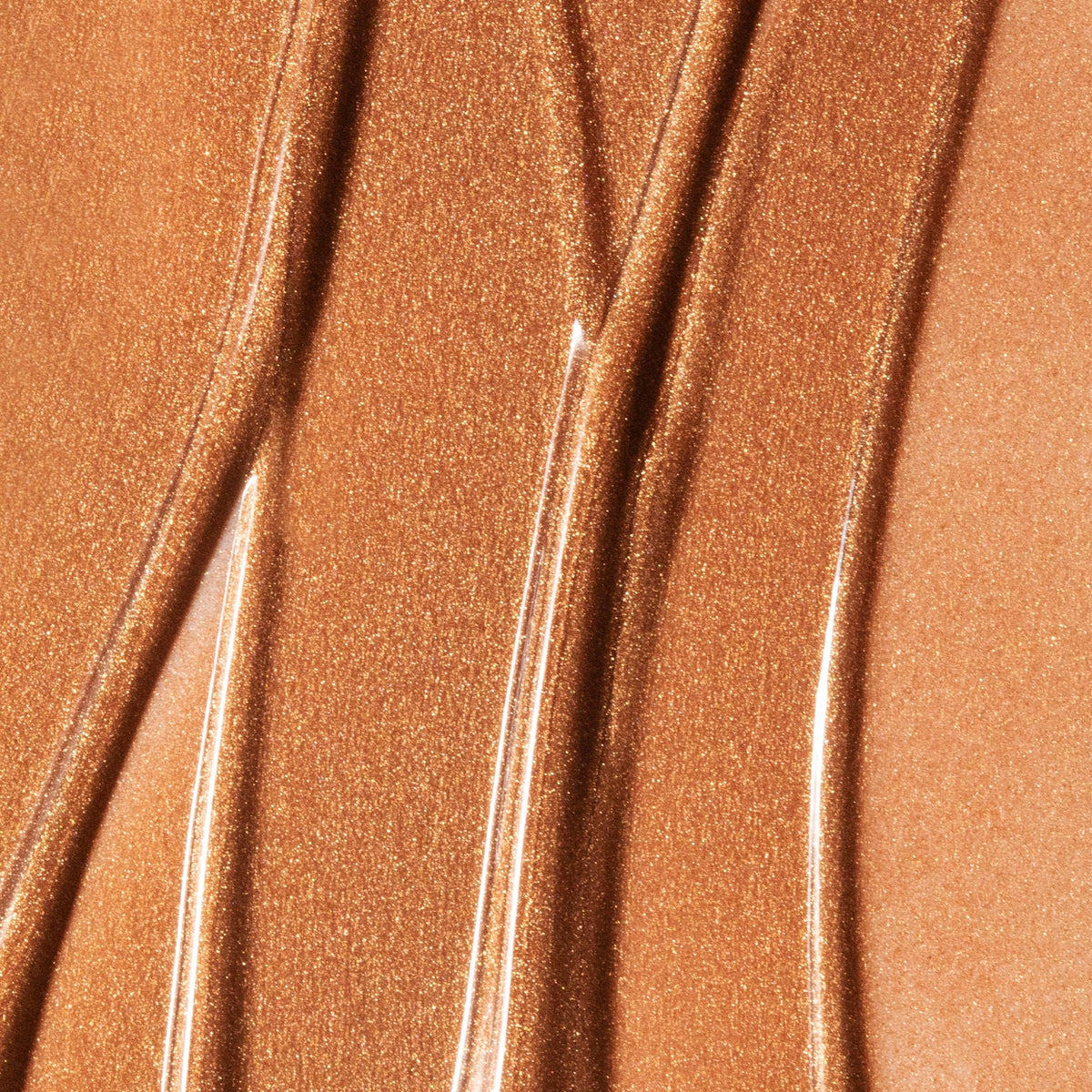 Summer Fridays bronzing drops applied on cheek, shows natural sun-kissed finish and blendability