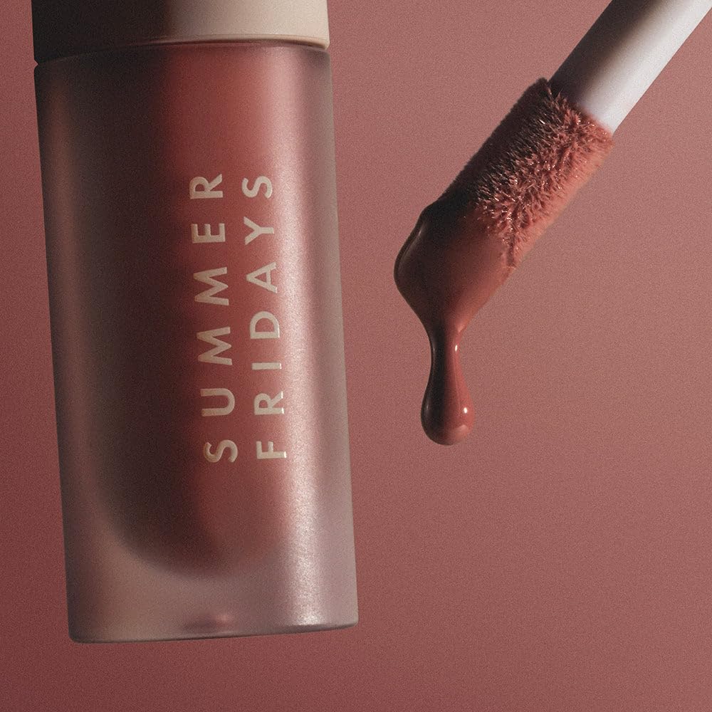 Summer Fridays lip oil in hand for scale showing compact travel-friendly size