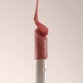 Summer Fridays lip oil staged with makeup showing layering over lipstick benefit