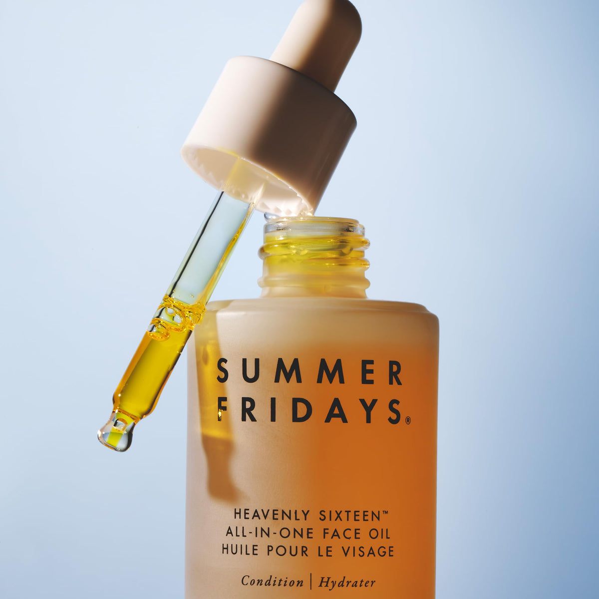 Summer Fridays bottle displayed near plant ingredients, communicates nourishing botanical blend