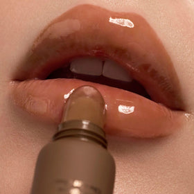 Summer Fridays layered over lipstick showing added shine and hydration benefit