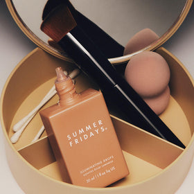 Summer Fridays bottle next to common items for 1 fl oz scale, clarifies product size