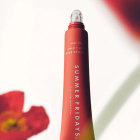 Summer Fridays applying on model lips showing glossy coral finish and smoothing benefit