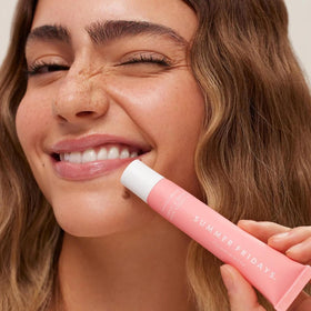 Summer Fridays layered over matte lipstick demonstrating shine and hydration