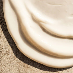 Summer Fridays pump dispensing lotion demonstrating controlled, mess-free application