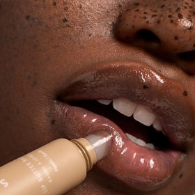 Vanilla bean prop beside Summer Fridays lip butter emphasizing soft vanilla scent