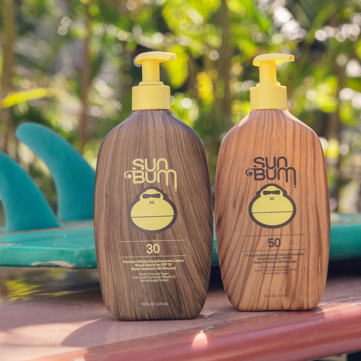 Sun Bum 16 oz bottle in hand showing scale for extended beach and family use