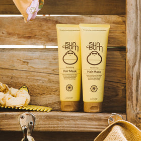 Sun Bum applied to wet hair in bathroom demonstrating easier detangling benefit