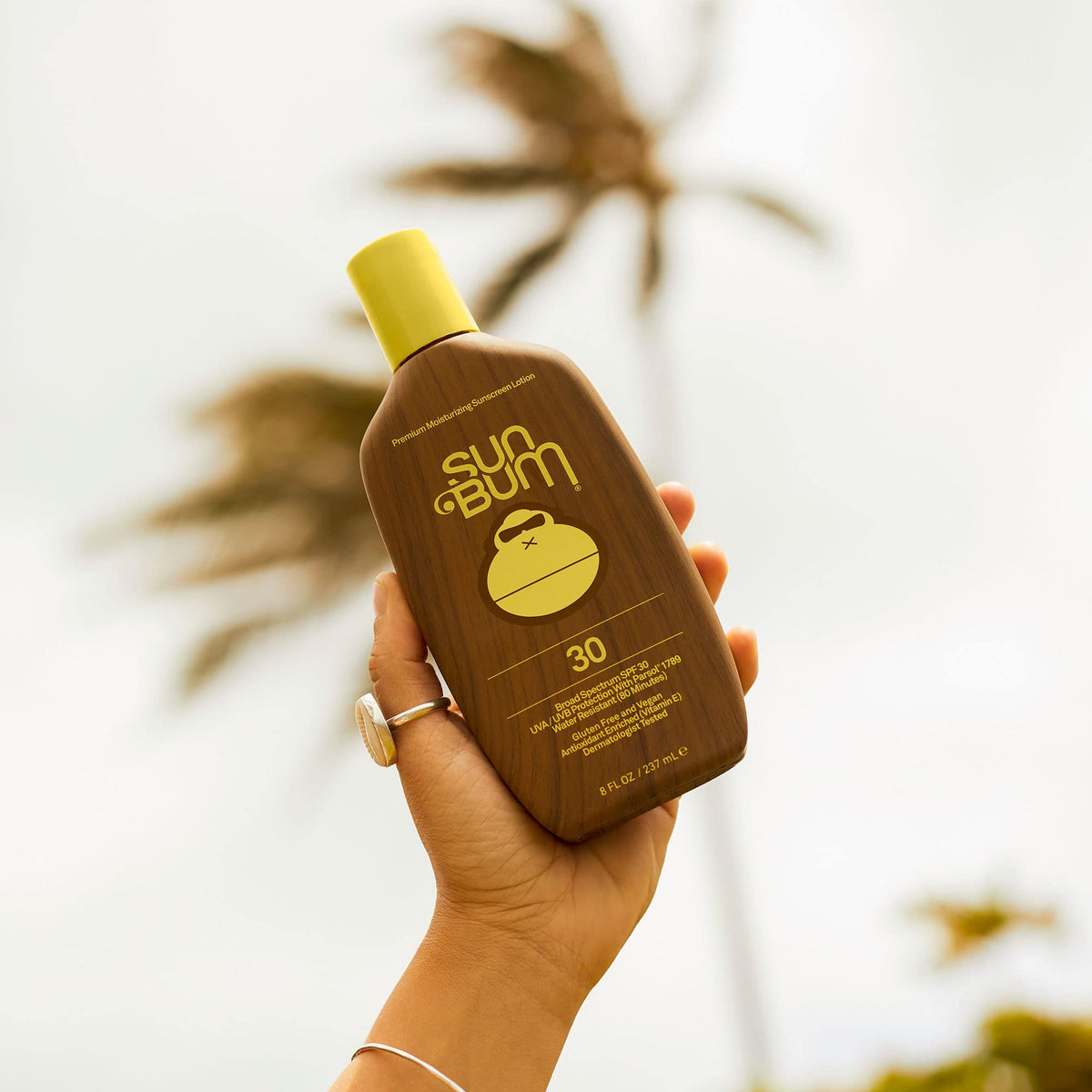 Sun Bum applying sunscreen to arm demonstrating easy coverage and water resistance