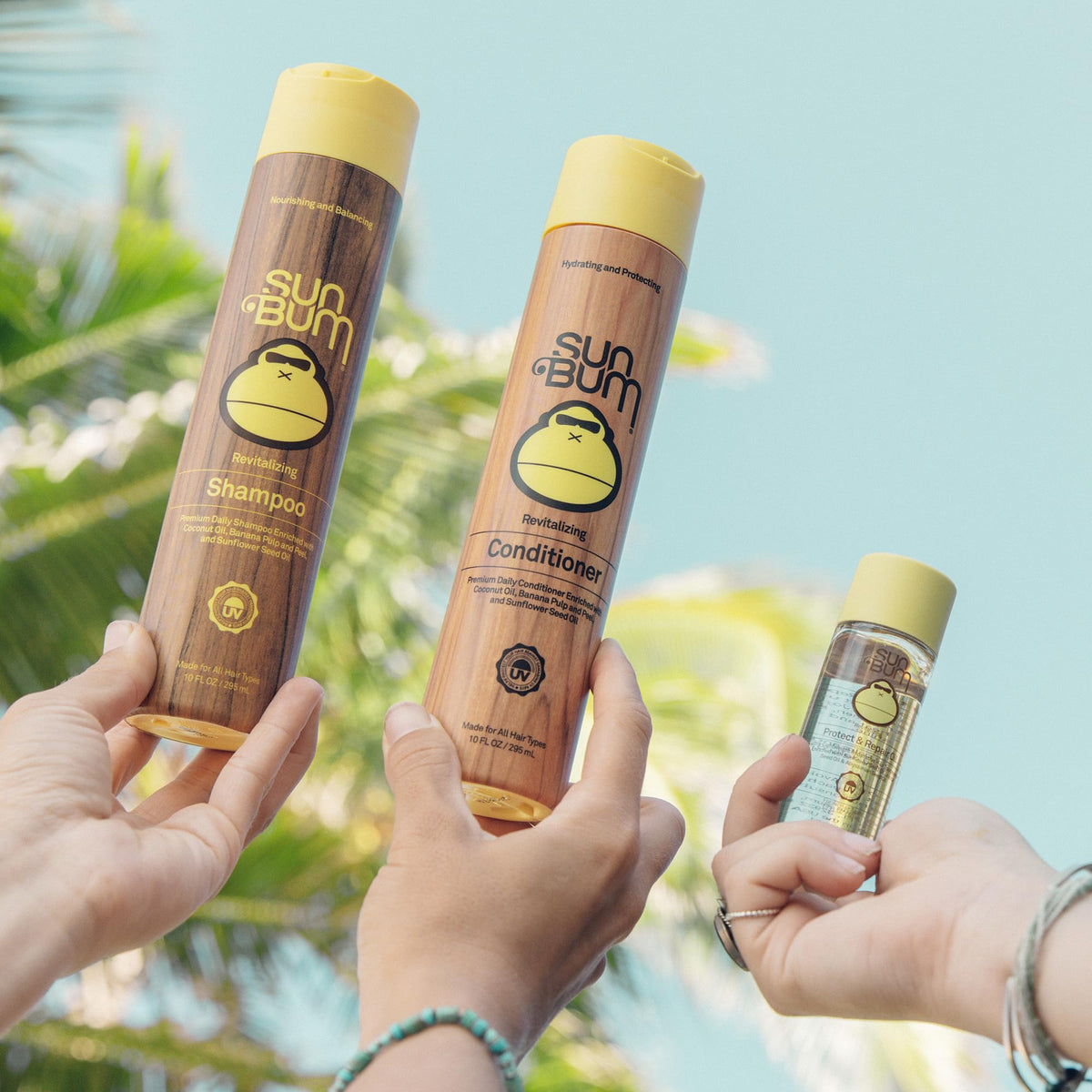 Sun Bum applying the oil to damp hair for heat protection and smoother styling