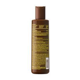 Sun Bum bottle beside beach towel in lifestyle scene conveying travel-ready protection benefit