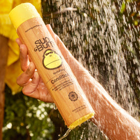 Sun Bum shampoo and conditioner in shower demonstrating lathering and rinse benefits