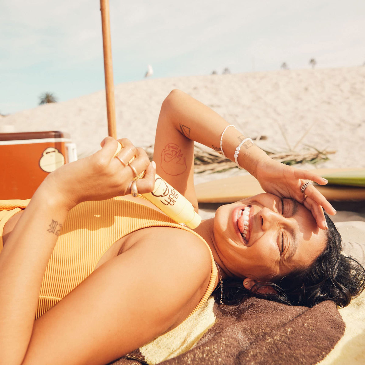 Sun Bum mist in hand demonstrating quick, even application benefit