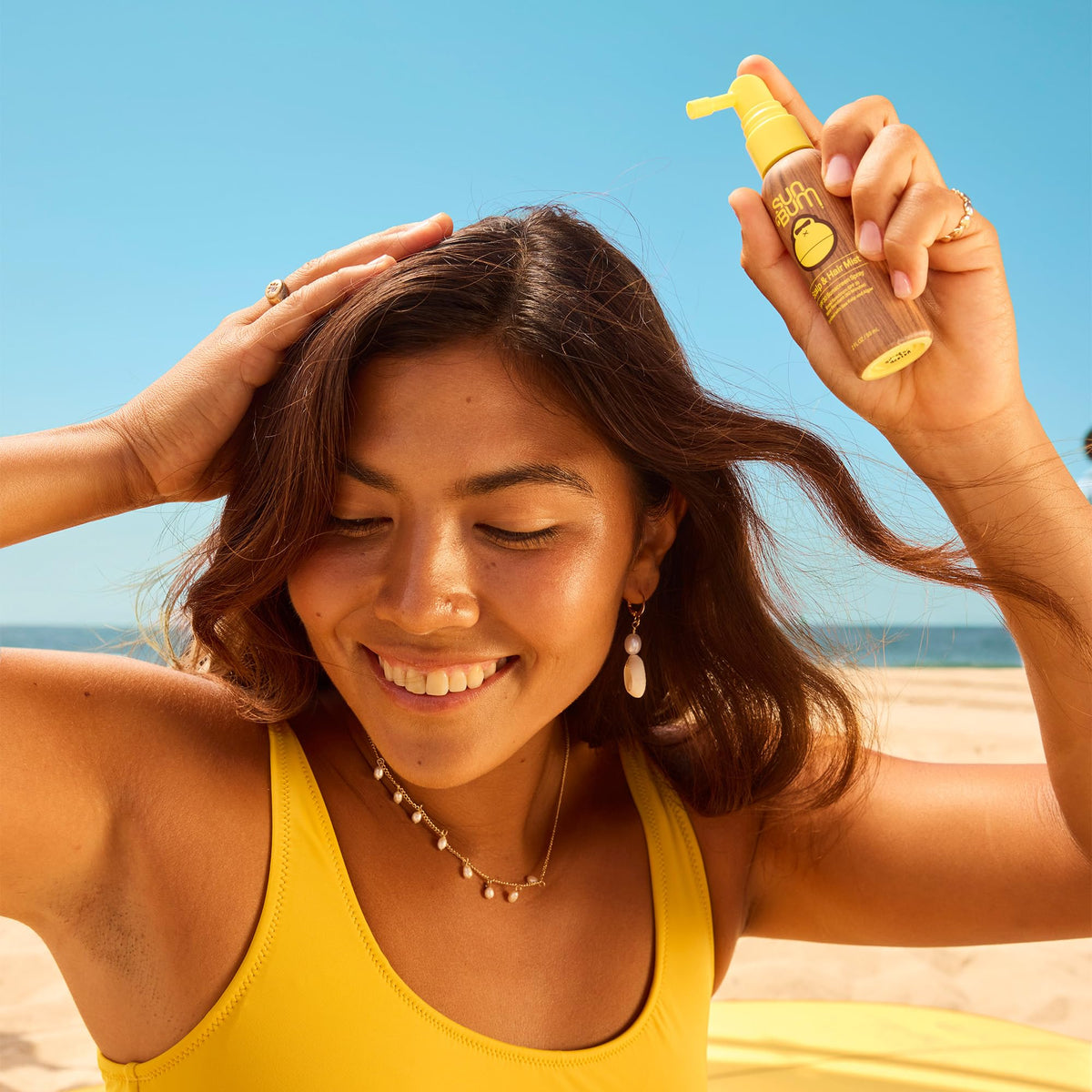 Sun Bum nozzle close-up showing precise spray for even scalp coverage