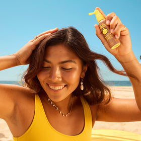 Sun Bum nozzle close-up showing precise spray for even scalp coverage