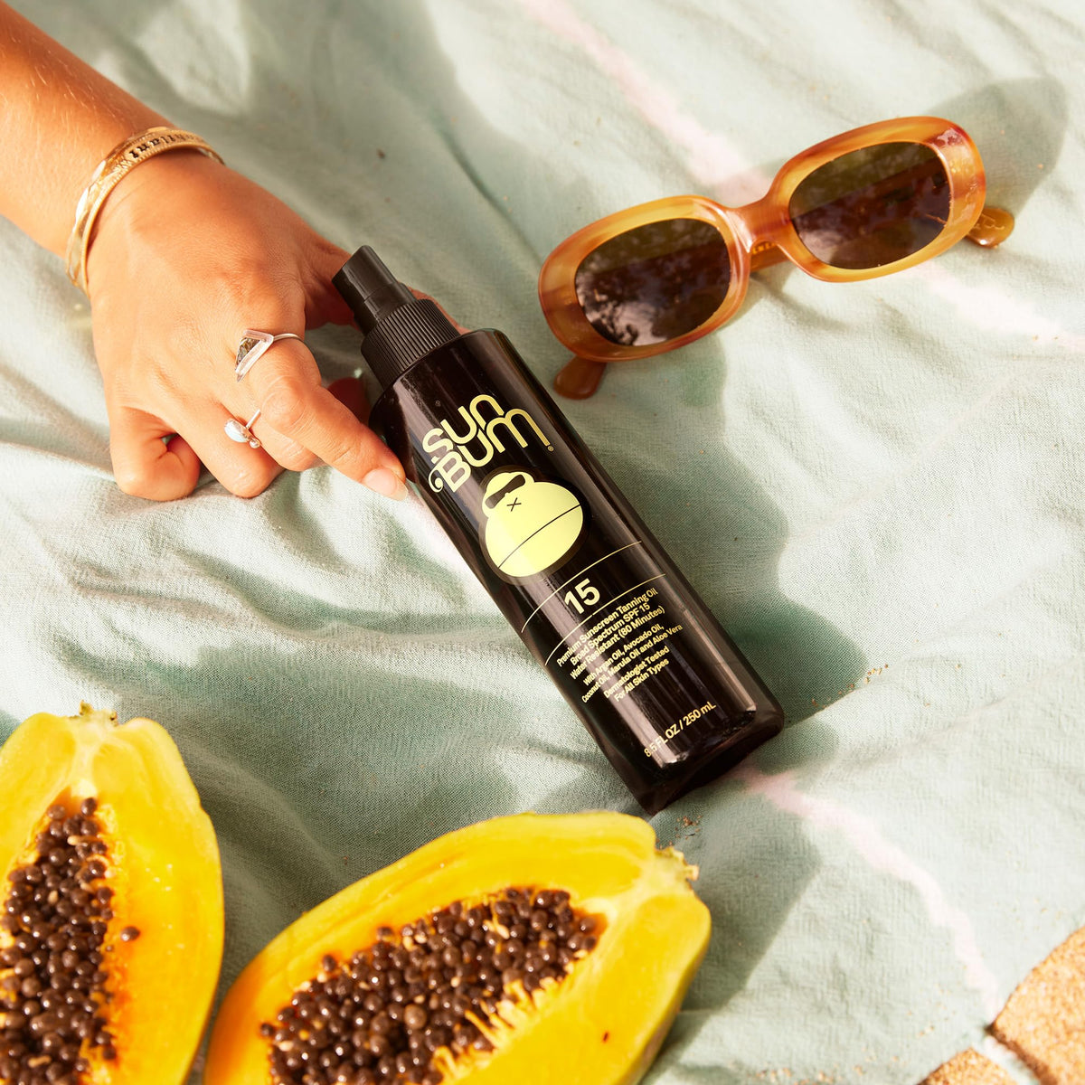 Sun Bum oil poured on hand highlighting moisturizing texture for smooth skin