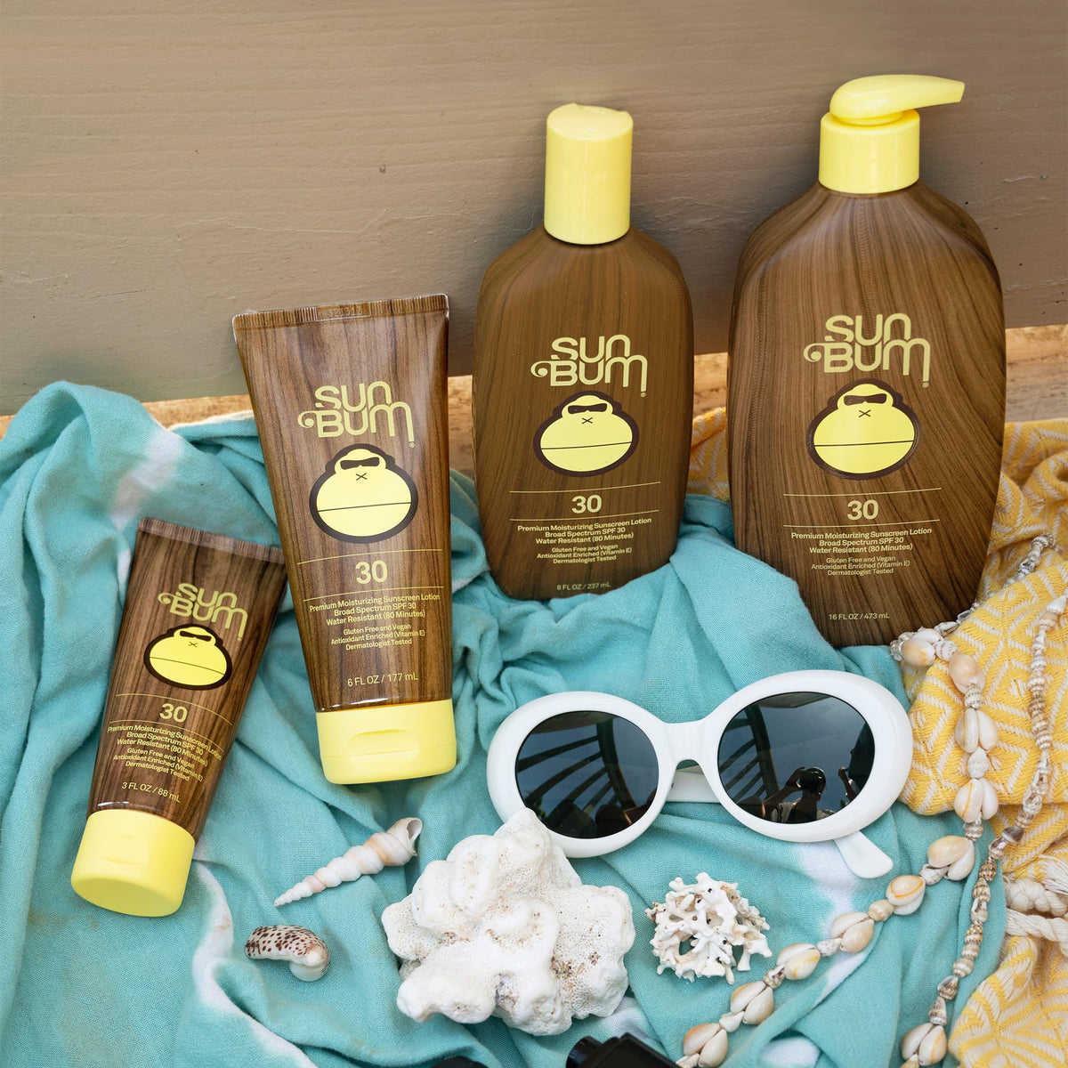 Sun Bum 8 oz bottle next to hand for scale and convenience