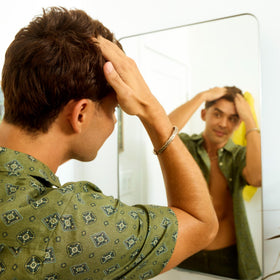 Sun Bum paste applied on damp hair demonstrating natural texture