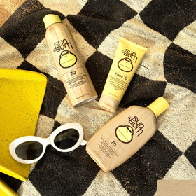 Sun Bum applying to cheek for facial protection during outdoor activity