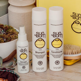 Sun Bum detangler applied to wavy hair showing smoother texture and shine