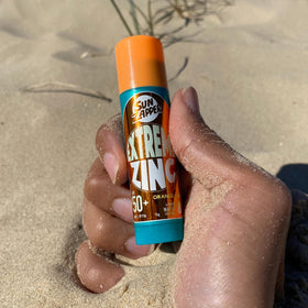 Sun Zapper athlete applying stick before surf showing fast, mess‑free prep benefit