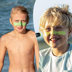 Family at beach applying Sun Zapper sticks for quick, visible sun protection