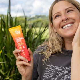 Sun Zapper in beach lifestyle shot protecting skin during outdoor activity