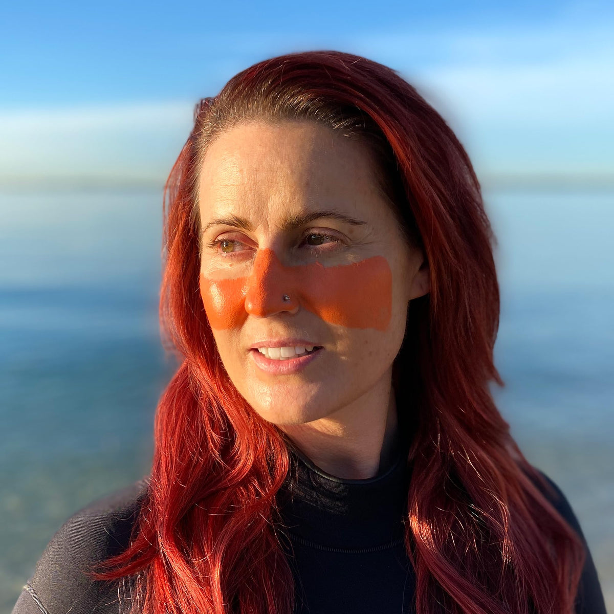 Sun Zapper orange stick applied to nose for precise high-UV protection