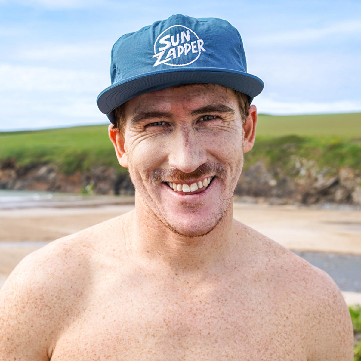 Surfer applying Sun Zapper stick before paddling for long-lasting protection