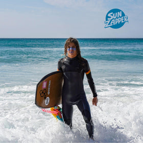 Sun Zapper surfer applying stick at beach showing quick on-the-water use