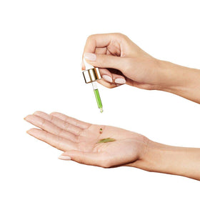 Sunday Riley dropper in hand dispensing oil, precise targeted application benefit