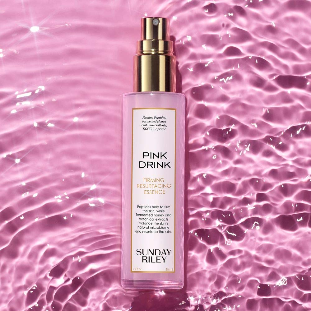 Sunday Riley Pink Drink texture droplet on finger showing lightweight absorbent feel
