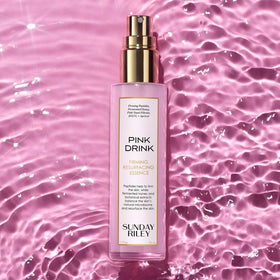 Sunday Riley Pink Drink texture droplet on finger showing lightweight absorbent feel