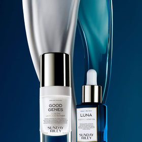 Travel-size 0.5 oz bottles next to a passport, showing Sunday Riley kit portability and on-the-go convenience