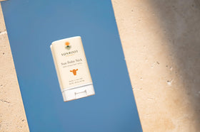 Sunroot Naturals sun stick tucked in pocket for convenient on-the-go reapplication