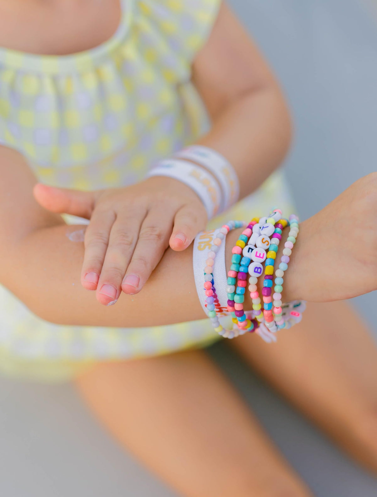 Sunshine & Glitter applied to child at beach promoting playful sun safety