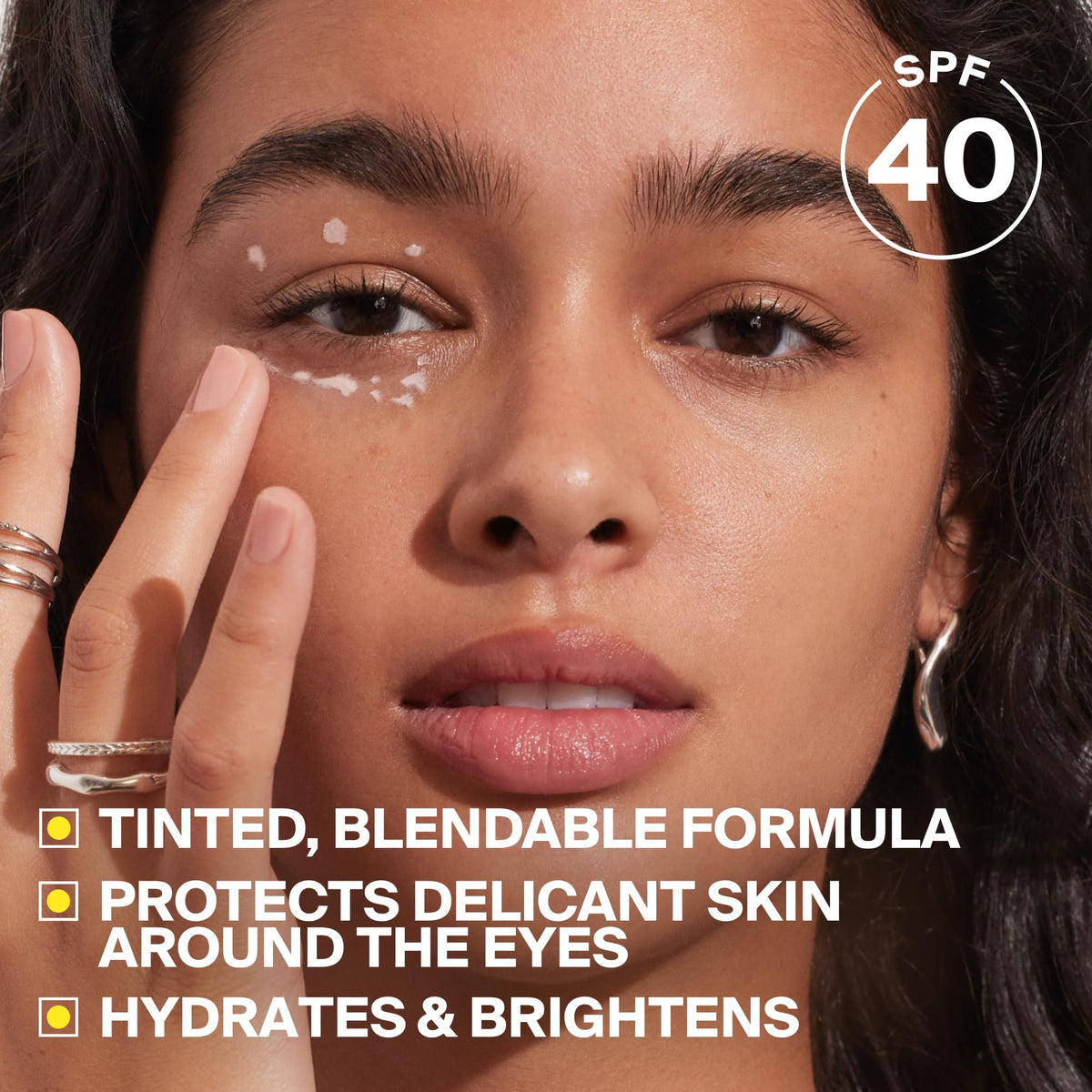 Supergoop! applying Bright-Eyed under eye for instant brightening