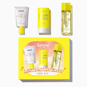 Supergoop! destination glow kit flatlay showing portable sunscreen trio and convenience