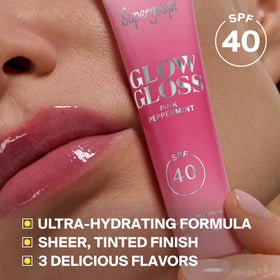 Supergoop! on lips close-up showing sheer coral tint and high shine